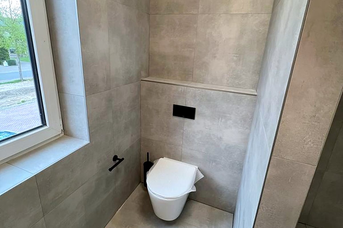 Licht toilet met raam en ingebouwde nis